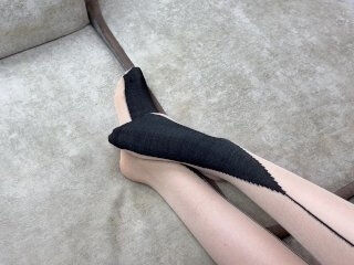 Solo caressing long legs in black nylon pantyhose