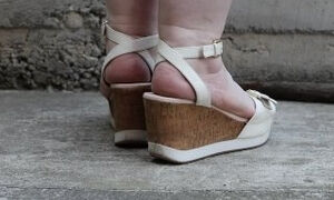 Chubby legs in high platform sandals.