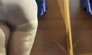 Curvy MILF in the mall fitting room trying on skirts