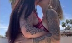 Sensual lesbian makeout by the pool