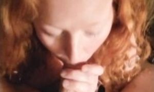 Redhead eats fruit rollup off cock