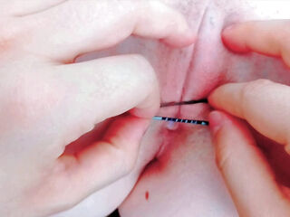 with tweezers destroying her pink pussy opening it