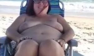 Milf naked on beach,  touchs herself as she teases