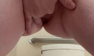 Horny red haired milf squirting in the bathroom at work