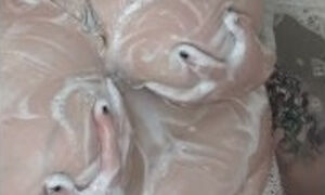 Goth BBW soaping up massive pierced tits in bath